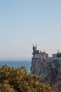 medieval castle on the edge of a cliff, tropical vegetation and the sea, landscape, sea pier