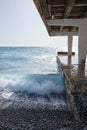 Waves crashing on the shore, concrete breakwater, seascape, small storm at sea