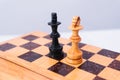 High quality photography. Two chess pieces on the board on a white isolated background. Black and white chess king. Worn chess set Royalty Free Stock Photo