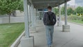 High quality picture of a young men who is walking outside on the street to to from parking lot on the train station. Royalty Free Stock Photo