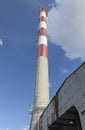 A high red-white concrete industrial chimney Royalty Free Stock Photo