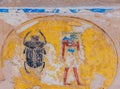 ancient Egyptian relief from the tomb of Irunefer with vivd colored detailed scarab (kheper) beetle and a god