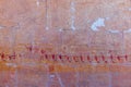 High Res ancient red limestone Egyptian vividly painted wall relief with detailed figures on a vessel