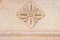 High res ancient rough pale stone with a centered arabesque inlay relief symmetrical pattern texture background