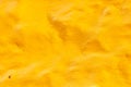 High res old vibrant gradient rich yellow multi tones semi smooth stone wall, texture background extreme close up Royalty Free Stock Photo