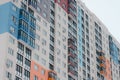 A high residential colorful building from a ground view. Orange, blue, green, red colors Royalty Free Stock Photo