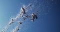 Dynamic silver splash explosion against blue sky Royalty Free Stock Photo