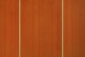 This high-resolution background texture captures the detailed grain of a vertical orange-stained wood surface, ideal for modern Royalty Free Stock Photo