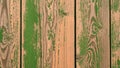 Detailed close-up of vertical wooden planks with rustic texture and peeling green paint revealing the natural wood grain Royalty Free Stock Photo