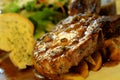High resolution grilled `kuro buta`pork ribs and black pepper sauce served with potato wedges,bread and salad