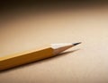 Sharp Yellow Pencil with Freshly Sharpened Tip on Smooth Surface Royalty Free Stock Photo