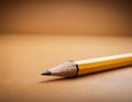 Sharp Yellow Pencil with Freshly Sharpened Tip on Smooth Surface Royalty Free Stock Photo