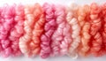 A high-resolution image of intricately twisted pink yarns, creating a soft and textured visua
