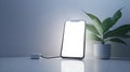 Smartphone Connected to a Charger on a Minimalistic Desk