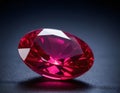 Exquisite Oval-Cut Ruby Gemstone, Isolated on Dark Reflective Surface Royalty Free Stock Photo