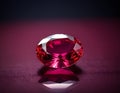 Exquisite Oval-Cut Ruby Gemstone, Isolated on Dark Reflective Surface Royalty Free Stock Photo