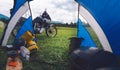 High resolution panorama. View from camp tent door. Motorcycle adventure bike on the background of green grass, forest and