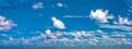 Daytime blue sky Background with white cumulus clouds. Soft focus