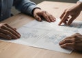 High-resolution photo of hands aligning flowchart diagrams on a wooden table, symbolizing collaborative project planning, teamwork Royalty Free Stock Photo