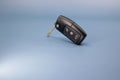 High resolution photo in 8k, car key on blue and white background, car open, close, trunk open symbol on black key, crop