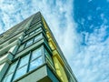 High-rise block building. corner of the house with glass and panoramic windows, block walls. modern high-rise building for people Royalty Free Stock Photo