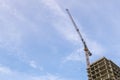 High rise building construction site with yellow crane against blue sky. Copy space for text Royalty Free Stock Photo