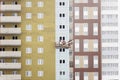 High-rise building under construction. Builders are engaged in external furnish of the walls. Royalty Free Stock Photo