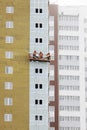 High-rise building under construction. Builders are engaged in external furnish of the walls Royalty Free Stock Photo