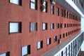 High-rise building with windows. Perspective and lines. Texture and background Royalty Free Stock Photo