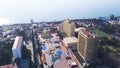 High-rise buildings located on coast on background of sea. Clip. Top view of developed tourist city by sea in summer