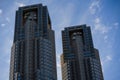 High-rise buildings standing proud in an urban cityscape with a clear blue sky in the background