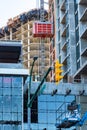 High-rise buildings under constraction with external elevator on the wall