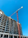 High rise construction site with concrete building and crane. Royalty Free Stock Photo