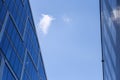 high-rise glass buildings against blue clouds, empty space for text, selective focus Royalty Free Stock Photo