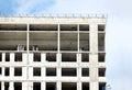 High-rise modern apartment building construction with flat roof and penthouses over blue sky with white clouds Royalty Free Stock Photo