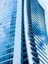 High-rise modern glass building reflecting the blue sky. Royalty Free Stock Photo