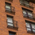 High rise with narrow balconies and brick wall Royalty Free Stock Photo