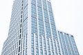 A high-rise office building with blue glass windows