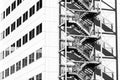 High rise office building with shadow of metal fire escape Royalty Free Stock Photo