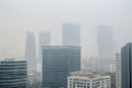 high-rise office building, with smog and air quality issues visible on the skyline