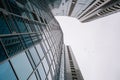 High rise residential apartment building with glass sun panels reflecting the sky on a cloudy day Royalty Free Stock Photo