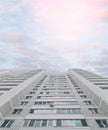 High-rise Residential Gray Building With Windows On A Background Of Pink And Blue Sky. Bottom View