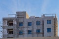 High-rise small building during construction, installation of window glazing, exterior design, wall insulation Royalty Free Stock Photo