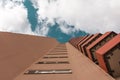 A high-rise with small red balkons with a view from below Royalty Free Stock Photo