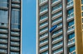 High rise window cleaner with cradle lift. Glass cleaner is working. Dangerous jobs in the building, cleaning and maintenance