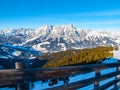 High rocky snowy peak on sunny winter day with blue sky. Alpine mountain ridge Royalty Free Stock Photo