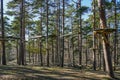 High rope bridge in a pine forest, part of a ropes course Royalty Free Stock Photo