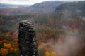 High sandstone cliff on autumn forest background, landscape near Pravcicka gate Prebischtor rock formation in Bohemian Royalty Free Stock Photo