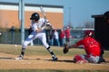 High school baseball batter takes a pitch at the knees