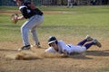 High school baseball player slides into base